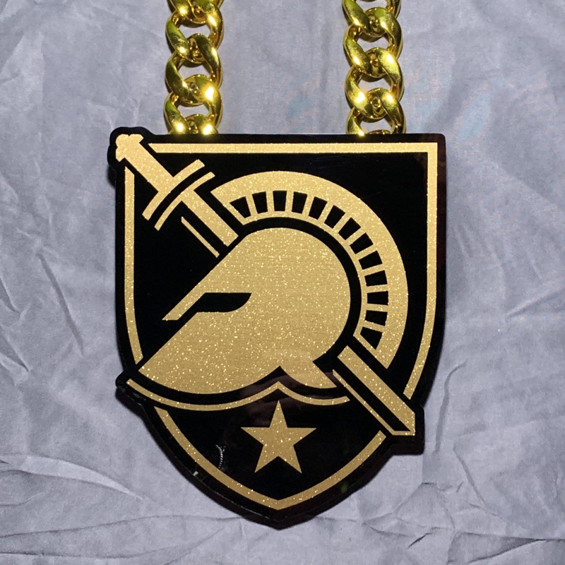 Black and gold spartan crest pendant on a gold chain